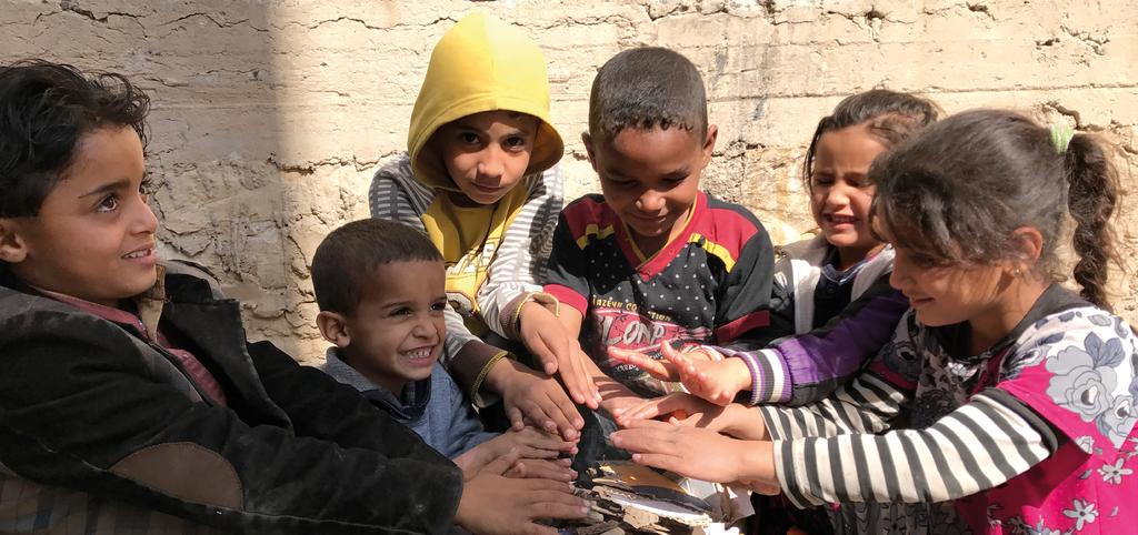 The need for common purpose UNHCR/Shadi Abusneida Displaced children warm their hands over burning scrap outside their home, a former commercial building now host to multiple displaced families in