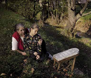 Zunovnica, Bosnia and Herzegovina. A mother grieves for her son Eldar, who died at this spot in August 2008.