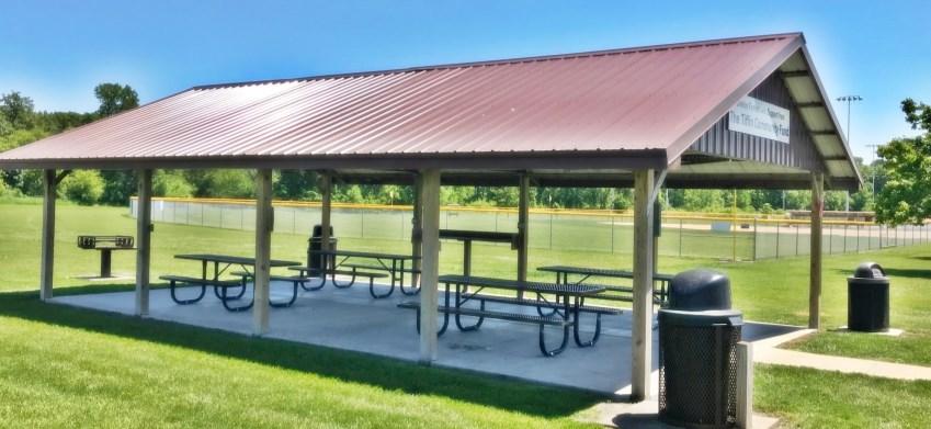 This shelter has 4 picnic tables, a charcoal grill and power outlets.