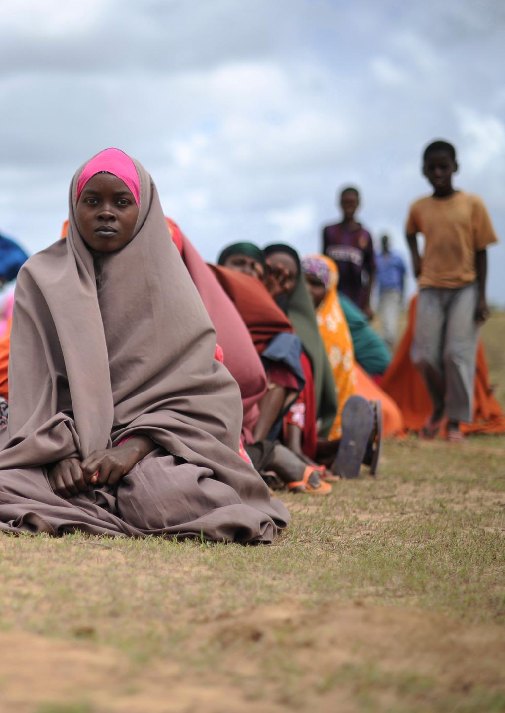 Displaced people waiting at a food distribution centre in Afgooye, Somalia, on 4 August 2013. Over 5,000 people were provided with food.