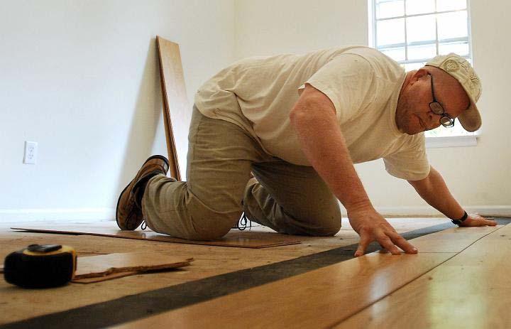 Rick Thomas installs hardwood floors in an Athens apartment complex as part of his construction job. Thomas graduated from the Day Reporting Center opened in 2008 by the Department of Corrections.
