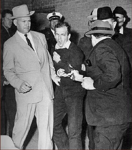 LEE HARVEY OSWALD CHARGED; SHOT TO DEATH A 24-year-old Marine with a suspicious pastlei a palm print on the rifle used to kill JFK He was charged and as a na@onal television