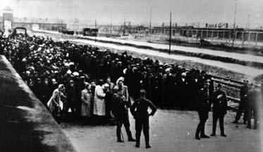 Figure 7-21 Prisoners, most of them Jews, stand on a train platform at the Auschwitz concentration camp in 1944.