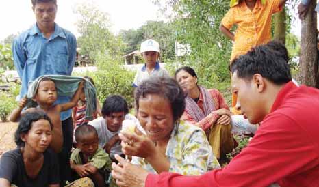Photo: AFSC Villagers being instructed on livestock vaccinations.