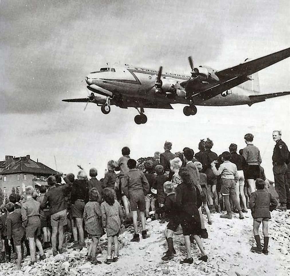 West Berliners watch a C-54 land