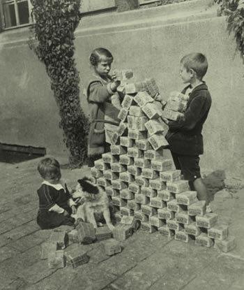 Children stacking banknotes and cash in Germany.