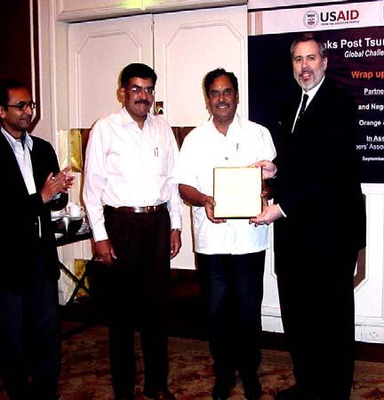 mid-2008 completion. U.S. Consul General David Hopper presents Cuddalore City Collector Rajendra Ratnoo a plaque of appreciation for his efforts in restoring the city of Cuddalore.