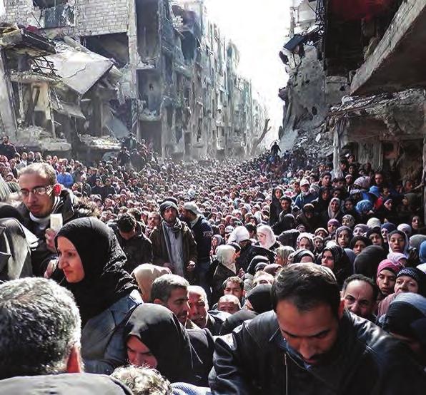 The iconic image of a huge crowd waiting for UNRWA food parcels in the Palestinian refugee camp of yarmouk, damascus - March 2014.