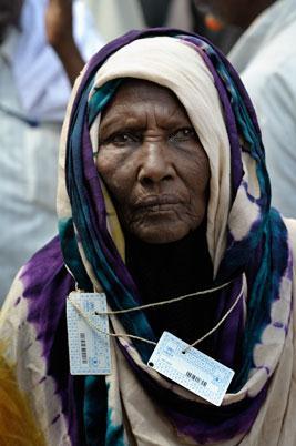 ACT/Paul Jeffrey A woman, her ration cards tied around her neck, waits in a line in the Dadaab refugee camp in northeastern
