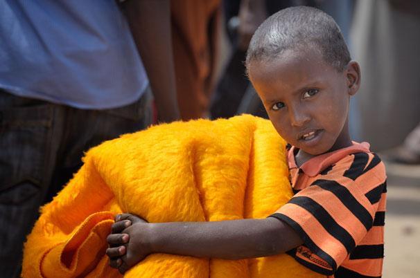 A boy receives a blanket from the ACT Alliance in the Dadaab refugee camp in northeastern Kenya.