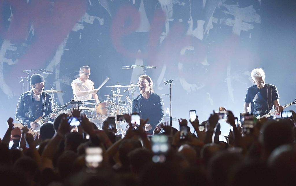 NEWS/FEATURES 17 The Edge (left), Larry Mullen Jr, Bono and Adam Clayton of U2 perform during a concert at the Apollo Theater hosted by SiriusXM on June 11, in New York.
