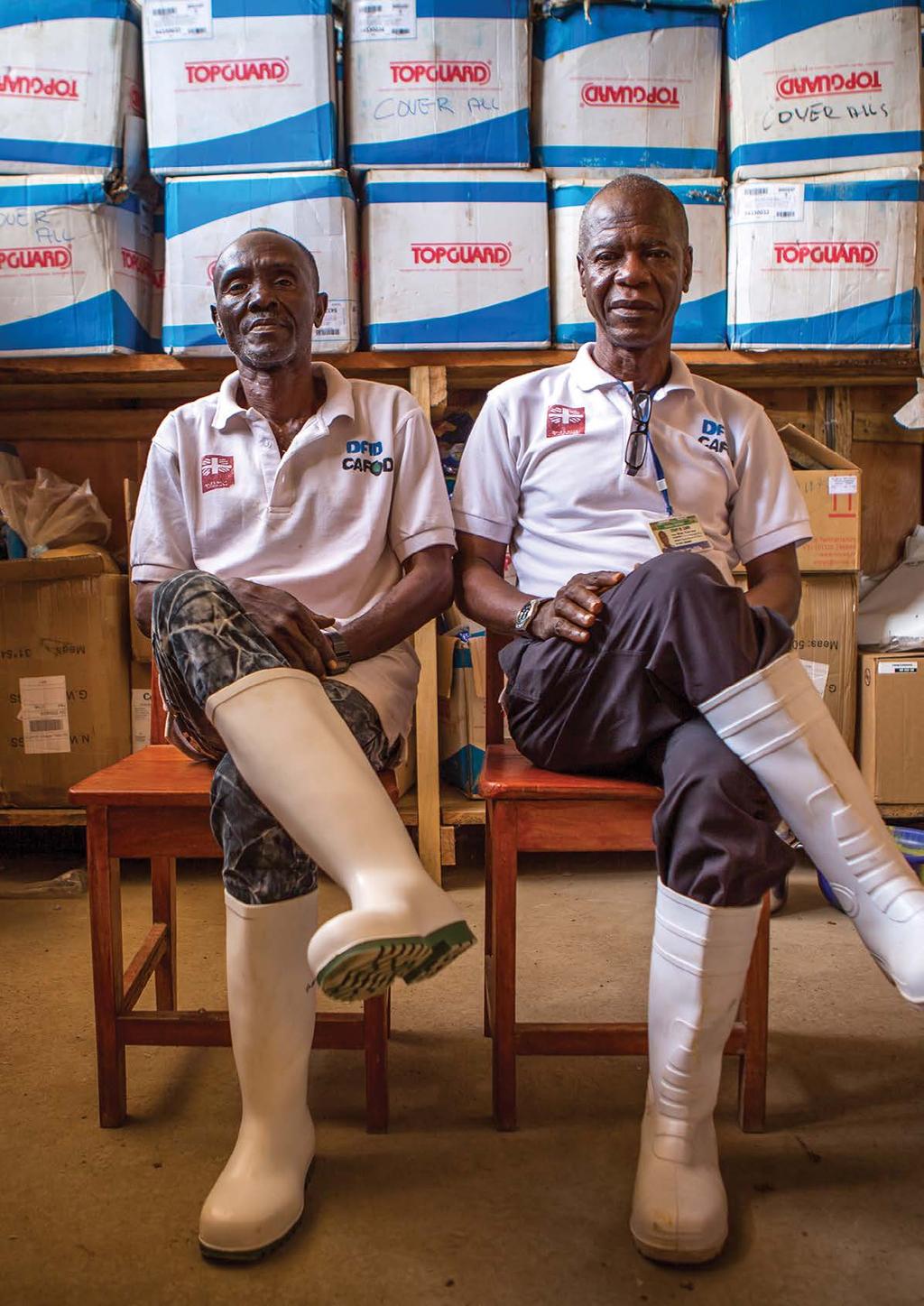 THE STORY Kambia, Sierra Leone April 2015 Albert Foday-Kamara (left), and Bai Turay, from the national health ministry, work with the