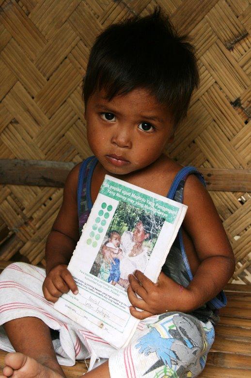 Tagbanua boy and his own MCH Handbook after Yolanda All households were victims of Typhoon Yolanda.