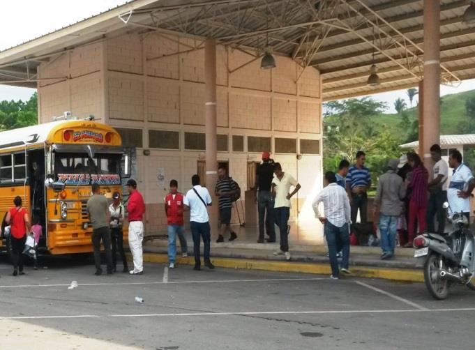 In the photograph below, a group of between 4 and 8 people can be seen trying to convince a mother (wearing red pants and a blouse with blue and red stripes) who had just been deported from Mexico