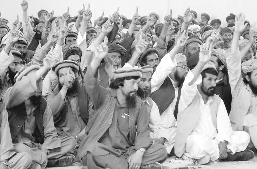 JOZJAN PROVINCE 135 Candidates elected in the first phase of Loya Jirga from the four districts of Parwan Province, North of Kabul, raise their hands before a vote during a meeting to elect a leader
