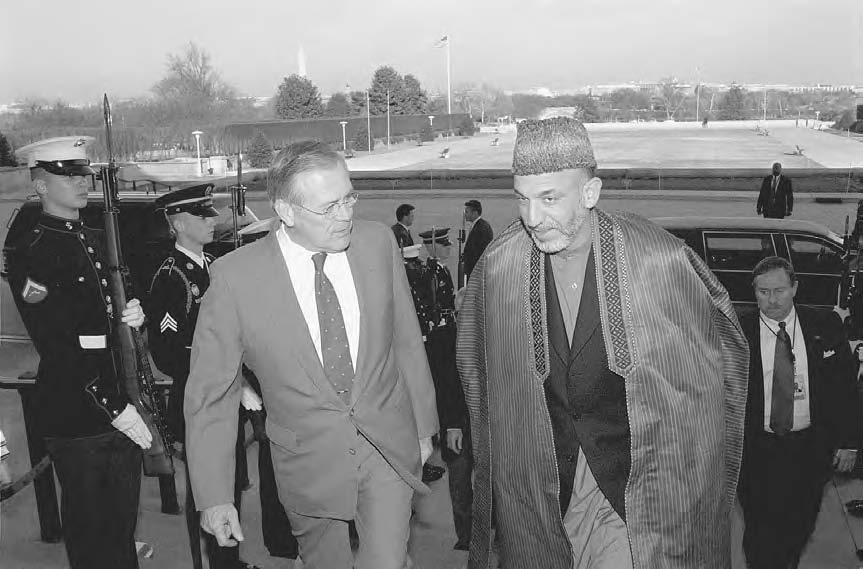 KARZAI, HAMID 143 Secretary of Defense Donald H. Rumsfeld (left) escorts Chairman of the Afghan Interim Administration Hamid Karzai through an honor cordon and into the Pentagon on 28 January 2002.