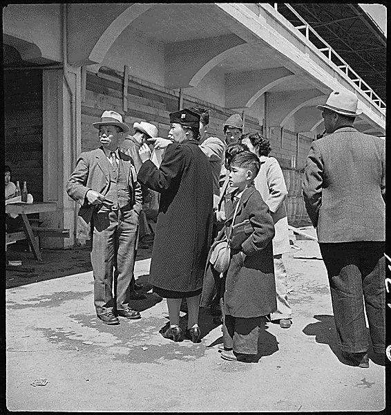 For the Traitors and Last Day chapter, students can look at this photograph of a Japanese family checking into an internment camp in