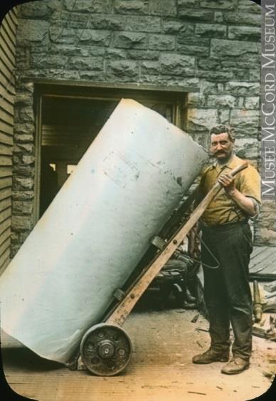 2 nd Phase of Industrialization 1900-1930 Worker transporting large roll of paper used for newspaper production.