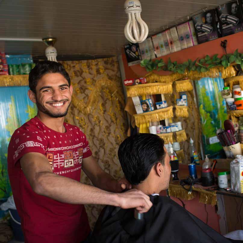 A Syrian barber cuts hair in the shop that he established in