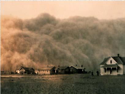 In this photo, a farmer and his children struggle against the wind during a 1936 dust storm.