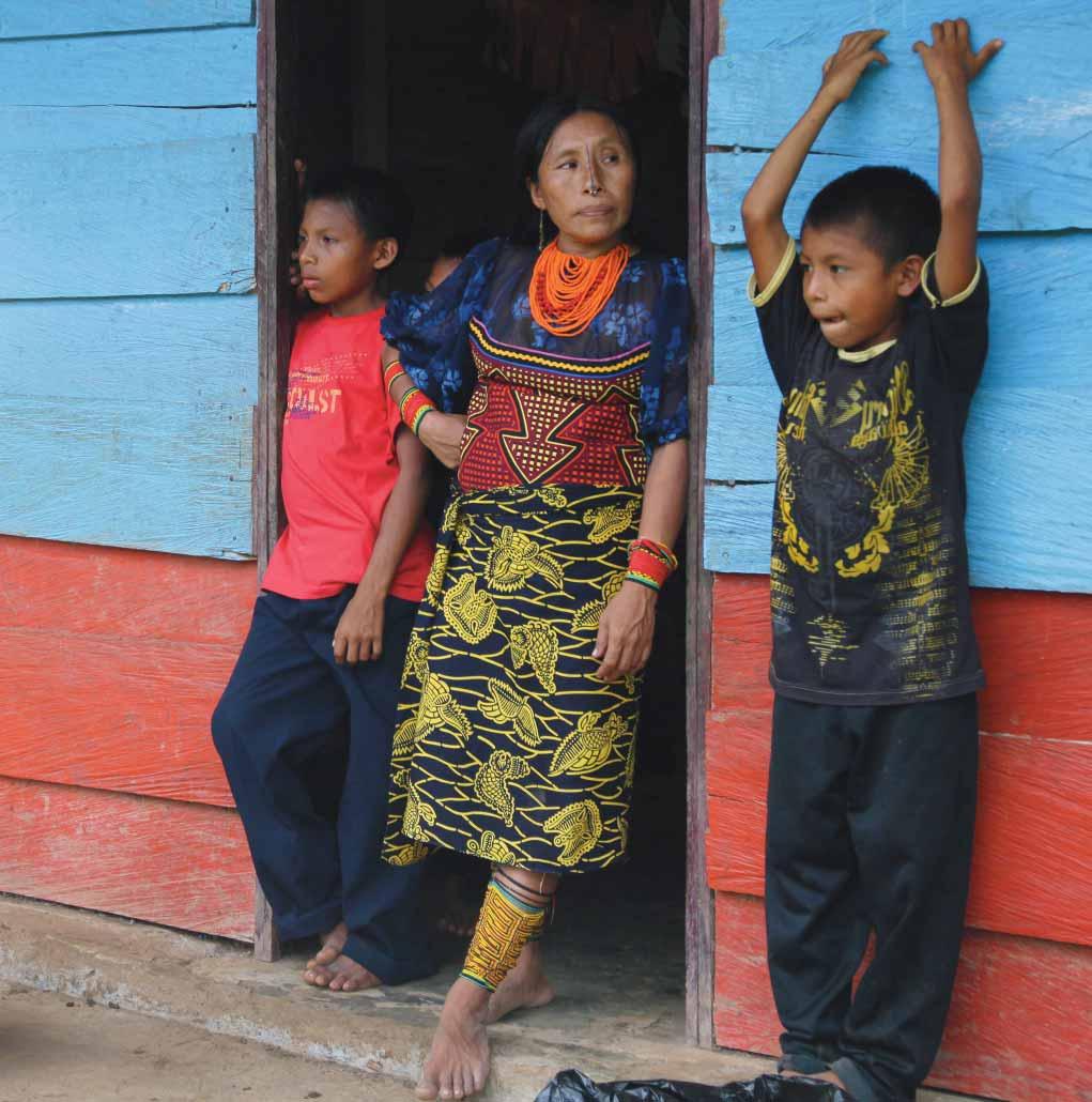 Returnees from the Tule indigenous group in Colombia s Chocó region stand in front of the community office in