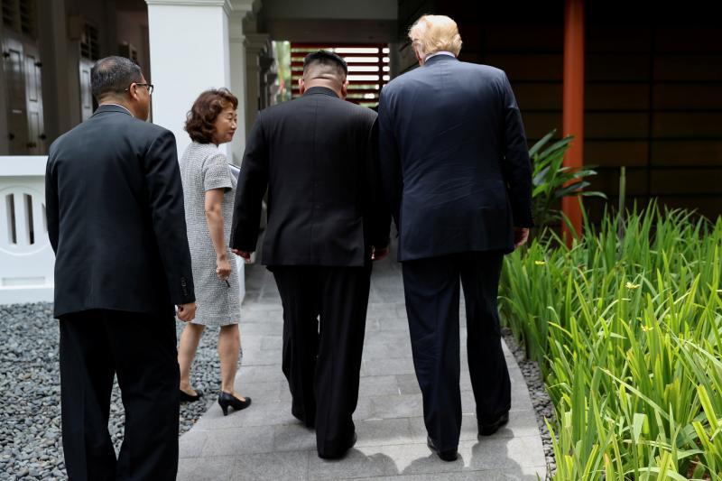 U.S. President Donald Trump and North Koreab leader Kim Jong Un walk together before their working lunch durin A SIX-TRACK PROPOSAL This broader approach could begin with a statement, perhaps
