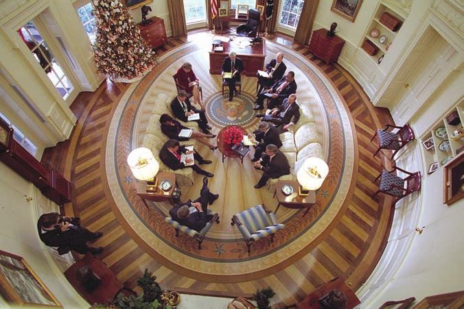 56 THE PRESIDENCY President George W. Bush held a meeting on December 20, 2001, in the Oval Offi ce, which was decorated with the new presidential rug that arrived earlier in the week.
