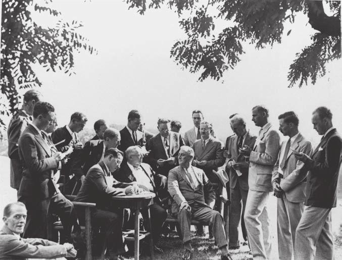 66 THE PRESIDENCY Journalists peppered President Franklin D. Roosevelt (seated, right) with questions during a news conference held at his estate in Hyde Park, New York, in August 1933.