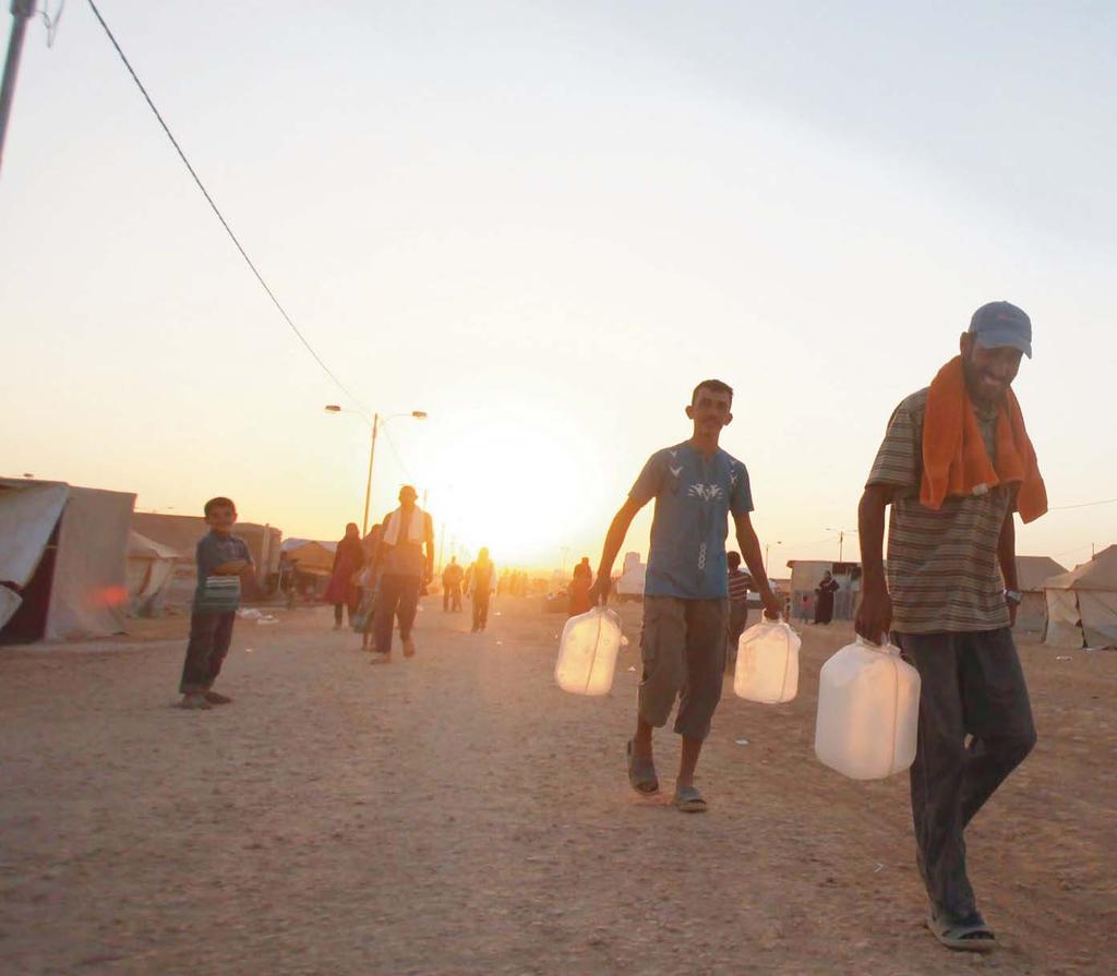 Syrian refugees in Al Zaatari camp, Jordan, walk to