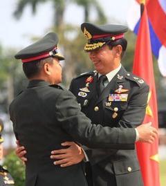 The Military, again Thai Maj-Gen Apirat Kongsompang (right),