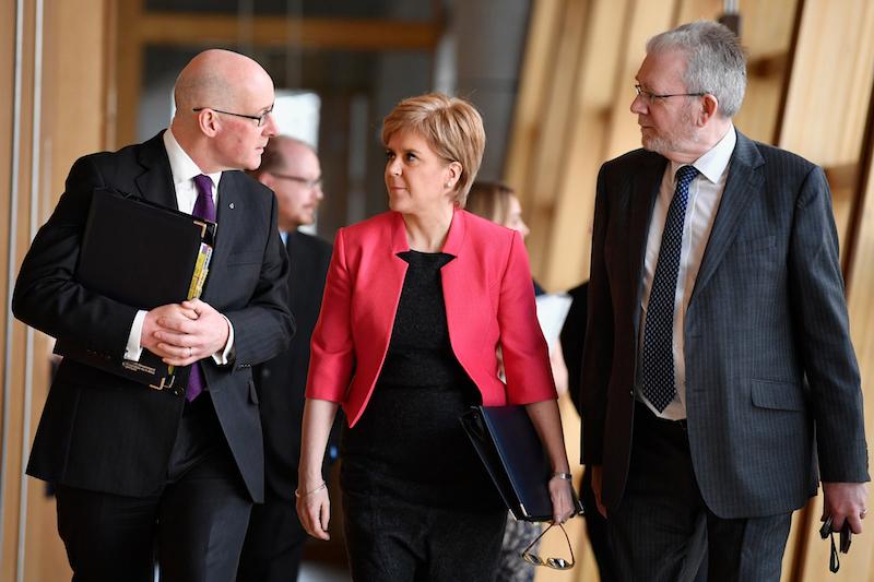 First Minister Nicola Sturgeon arrives for First Minister's Questions with deputy John Swinney and Brexit minister Mike Russell inside the Scottish Parliament on March 16, 2017 in Edinburgh, Scotland.