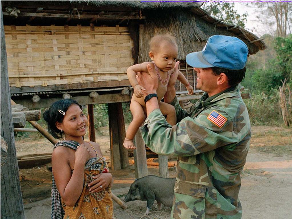 A united Nations Military Observer from the United states plays with a baby from the Krung-Brau tribe in Ratanankiri Province where have a lot of ethnic