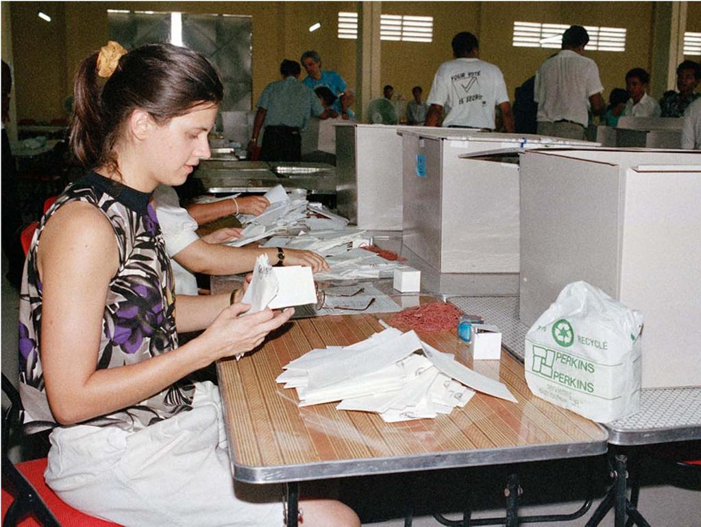 A United Nations staff member counts the votes at the