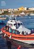 In Lampedusa s harbour, Italy, a patrol boat returns with asylum-seekers from a search and rescue mission in the Mediterranean Sea.